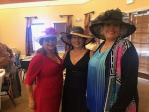 ladies in hats and gloves at Centennial Tea